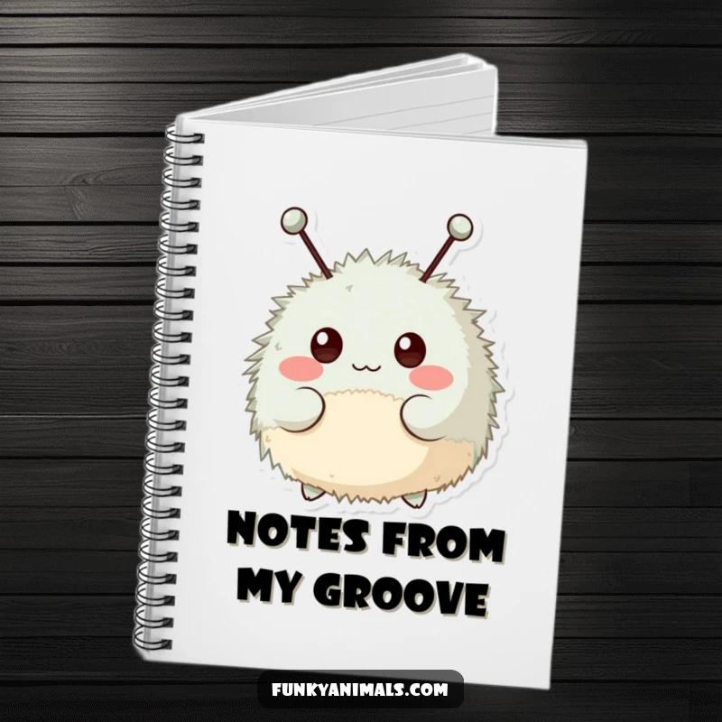 Funny notebook cover featuring a fuzzy, round creature with antennae bopping its head rhythmically.